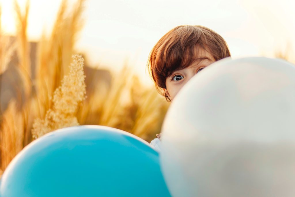 Child with balloons. Creative commons image from Unsplash.